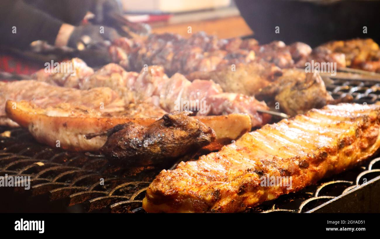 Fried pork ribs. Grilled pork kebabs on a teapot. Barbecue Kid on the grill. grilled kebab