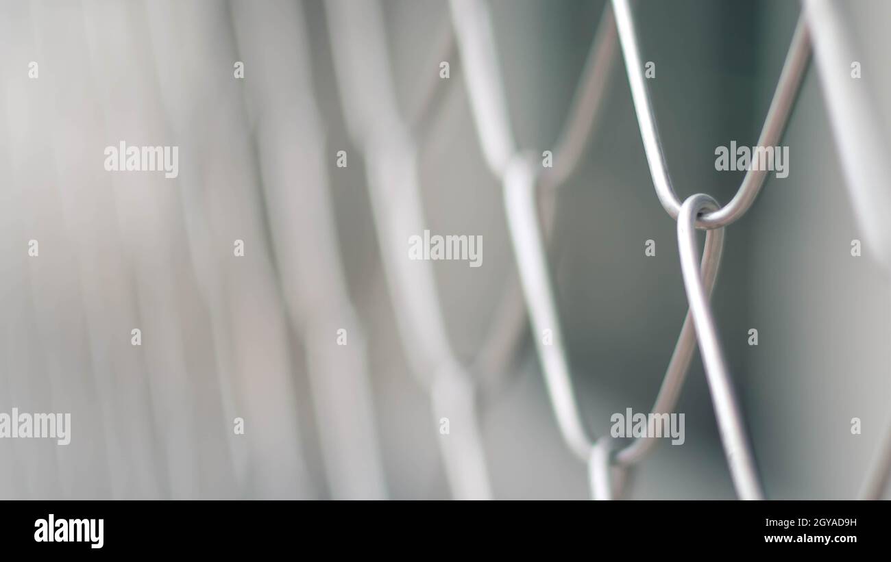 Close up Solid Metallic Wire Mesh Chain link Fence in Vintage Style Steel. Selective focus wire mesh fence Stock Photo
