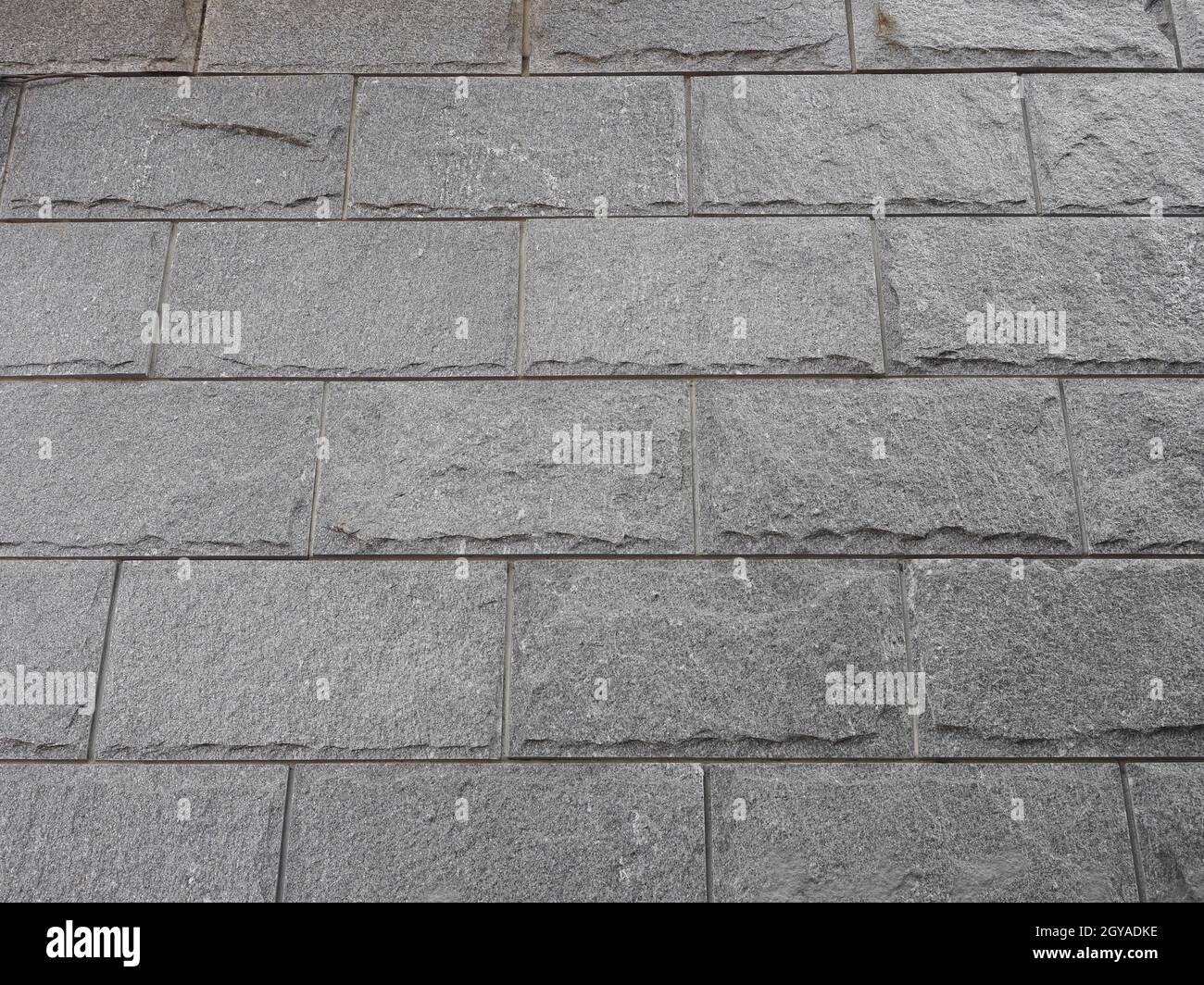 grey stone wall useful as a background Stock Photo - Alamy