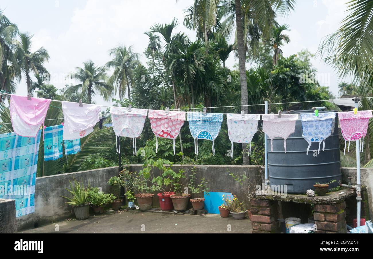 Baby clothes on the roof hang up in Sunlight. Clothes hung on clothesline for drying on terrace