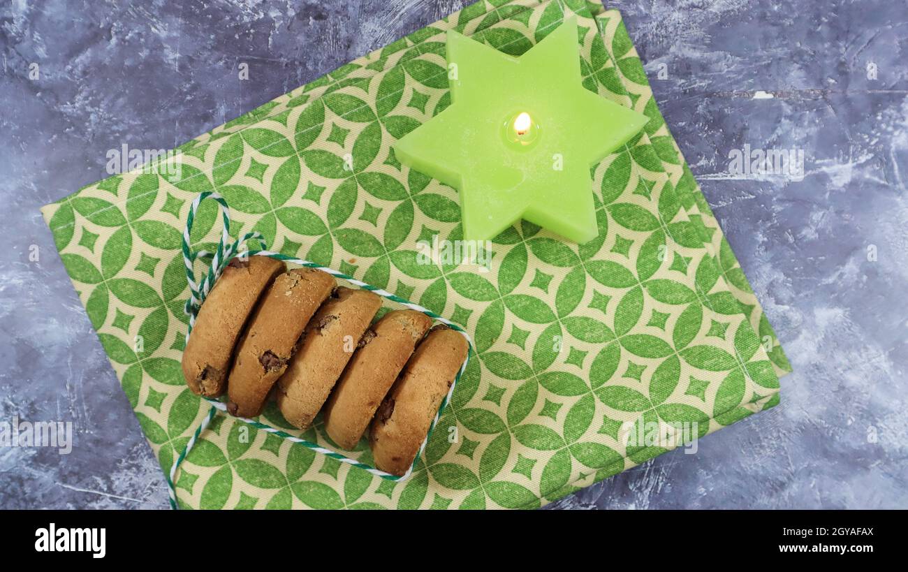 American chocolate chip cookies in a stack tied with thread on a green ...