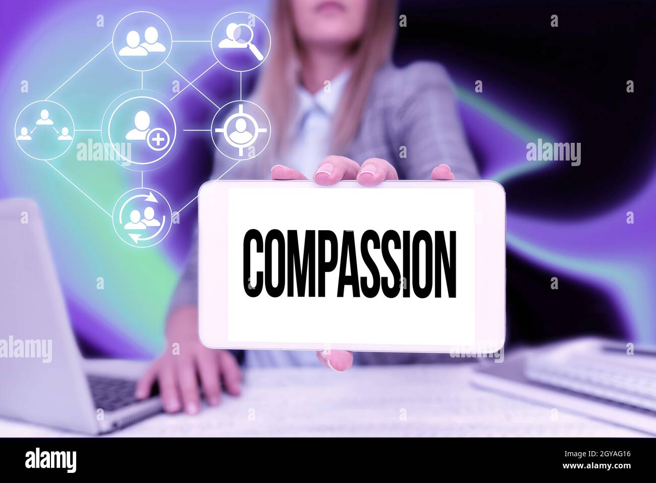 Hand writing sign Compassion, Internet Concept empathy and concern for the pain or misfortune of others Business Woman Sitting In Office Holding Mobil Stock Photo