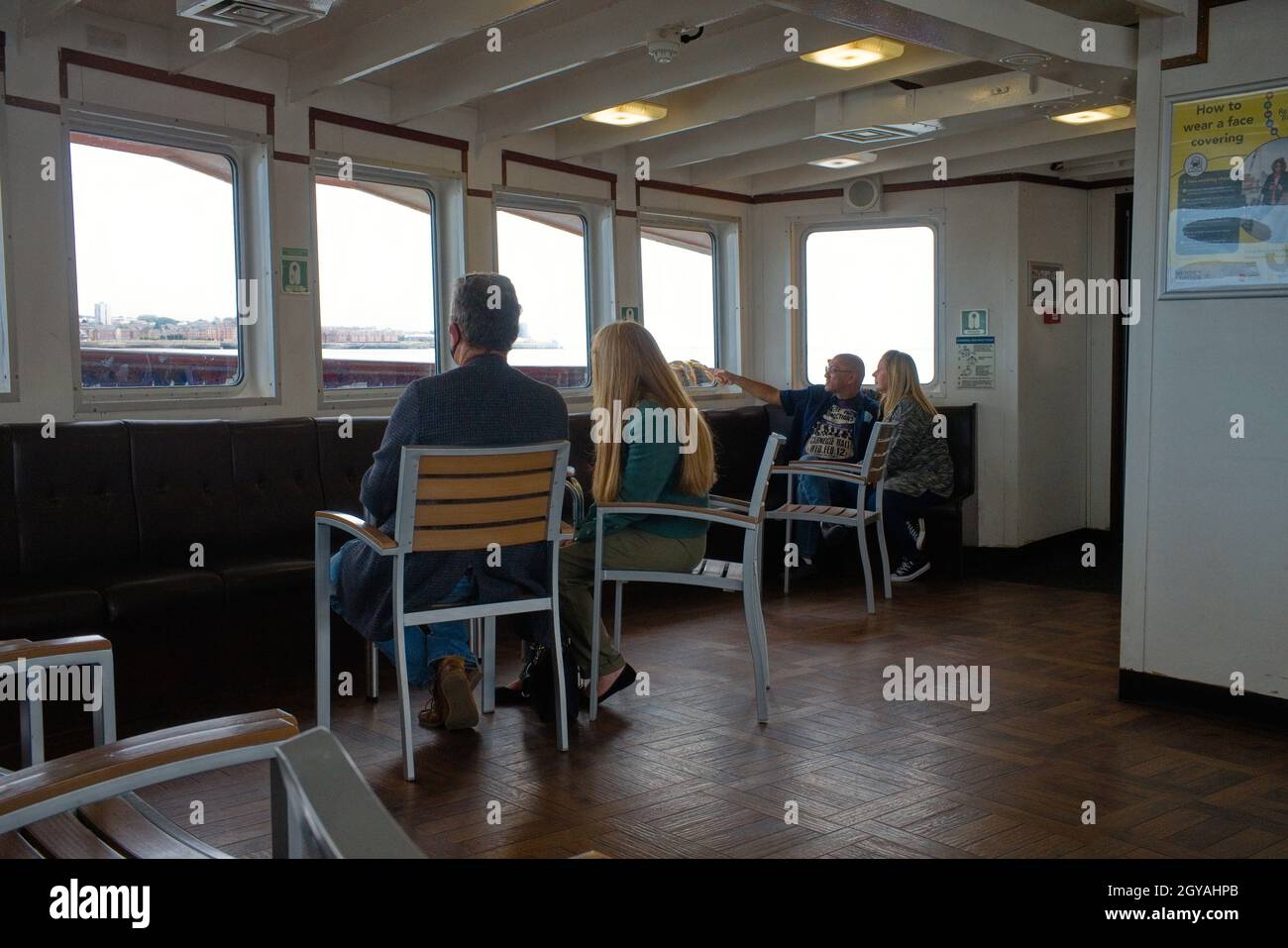 Passengers on the inside of the Mersey Ferry, Snowdrop during covid times Stock Photo
