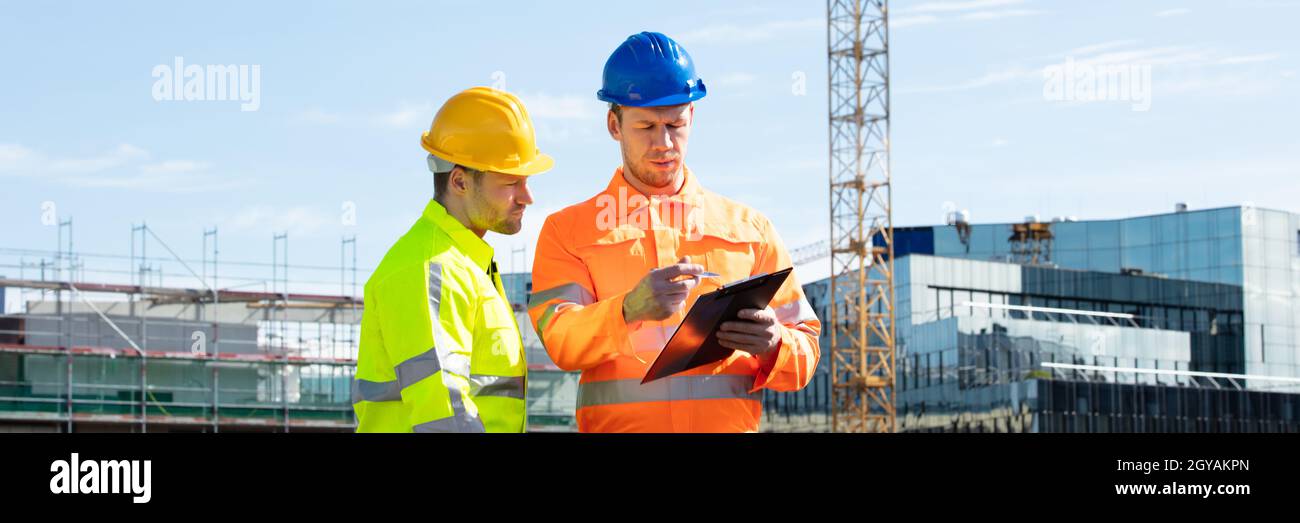 Construct Site Engineer Pointing. Worker Inspector With Clipboard Stock Photo