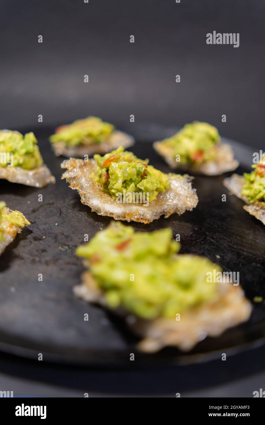Pork rinds with guacamole on traditional Mexican comal Stock Photo Alamy