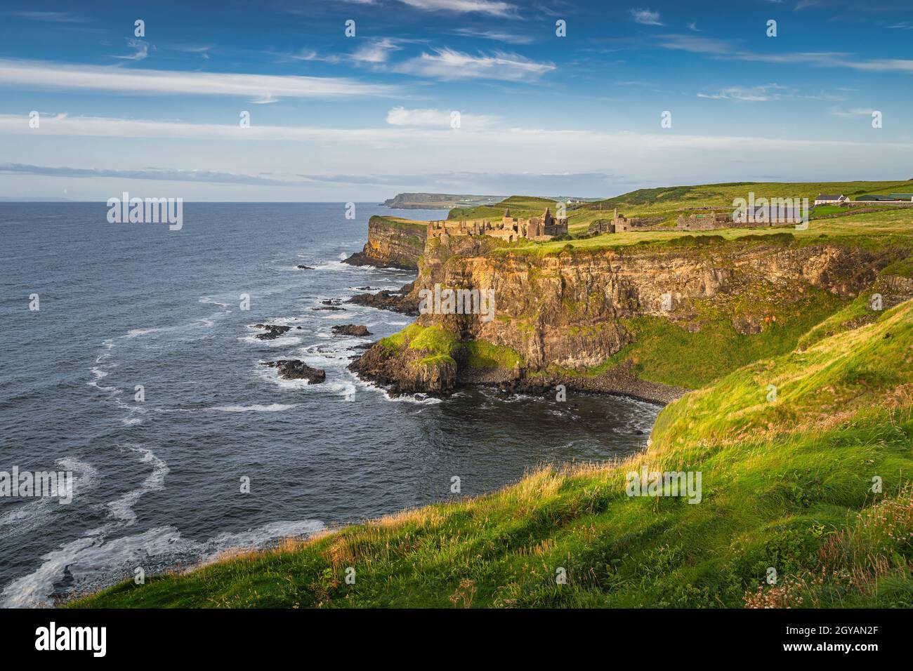 Spectacular coastline, Dunluce Castle located on edge of the cliff, Bushmills, Northern Ireland