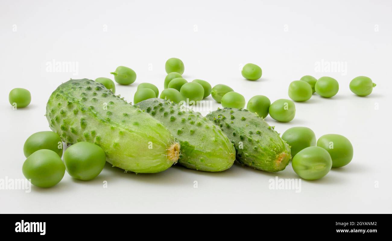 Cucumbers and peas isolated on white background Stock Photo