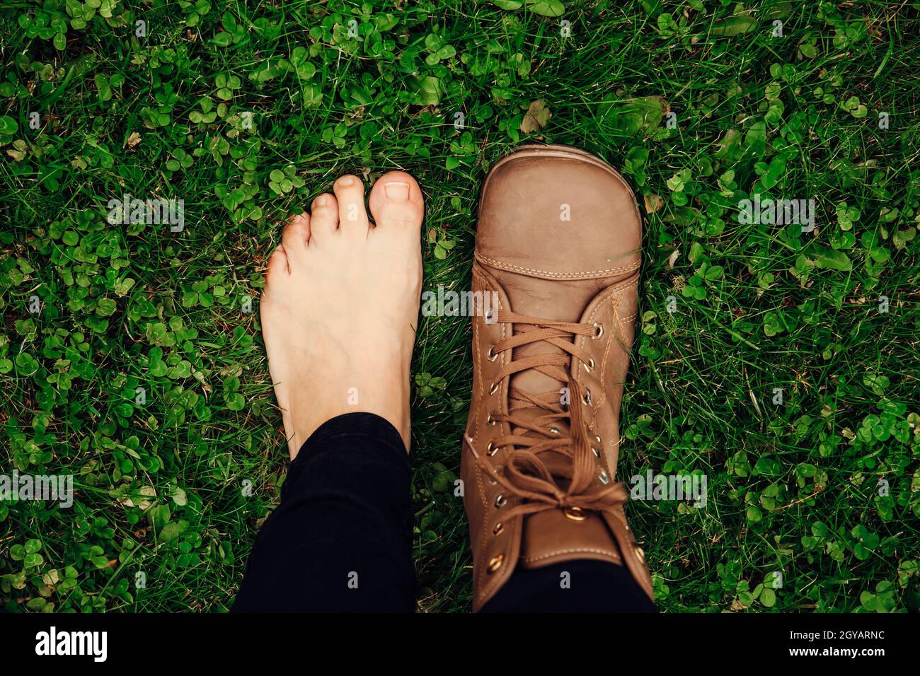 Person wearing barefoot boots shoes, which are wide, comfortable and healthy concept. Wide toebox fits all toes without compressing them together. Stock Photo
