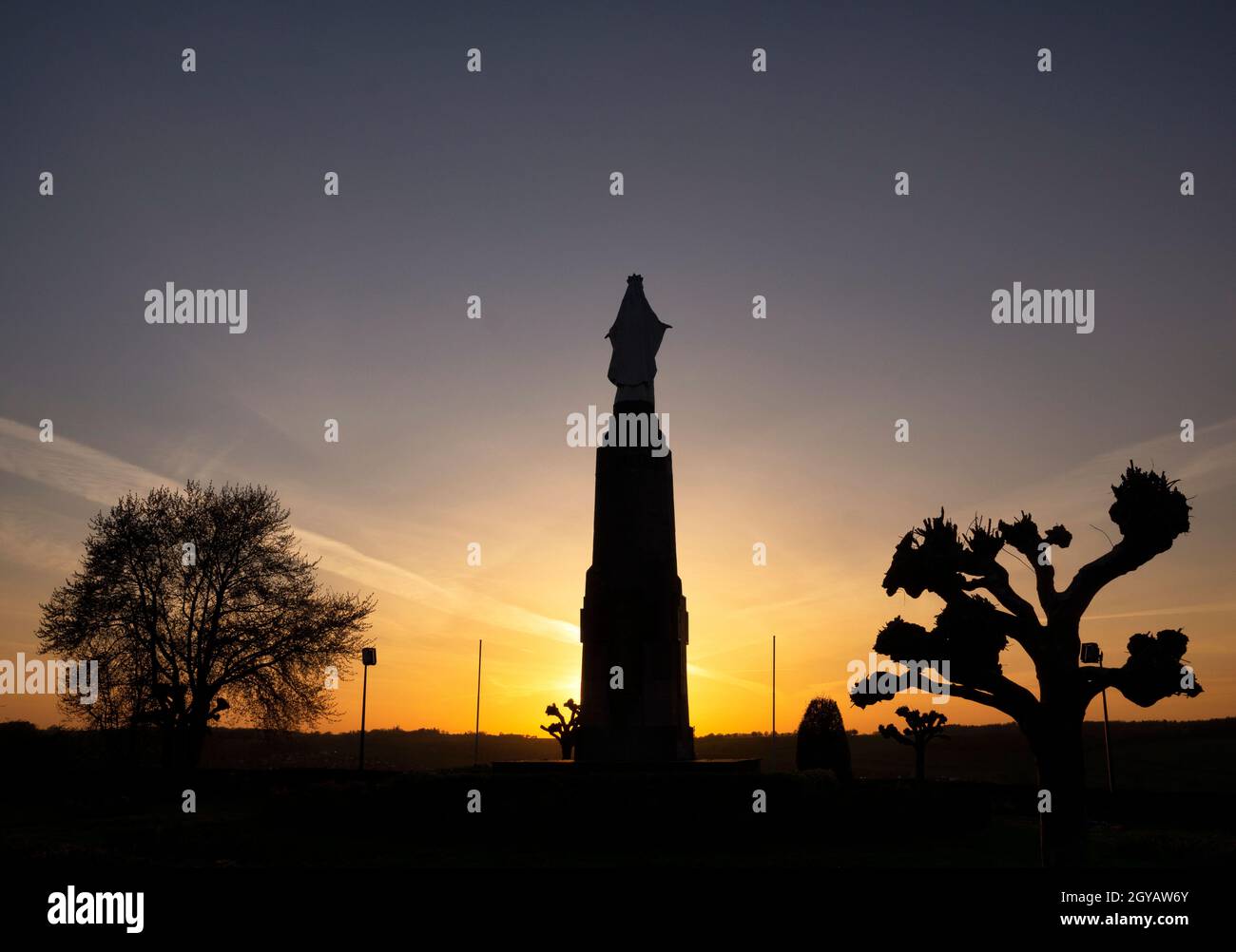 Silhouette from a Maria statue on the Gulpenerberg in the evening near the Dutch village Gulpen in the province Limburg Stock Photo