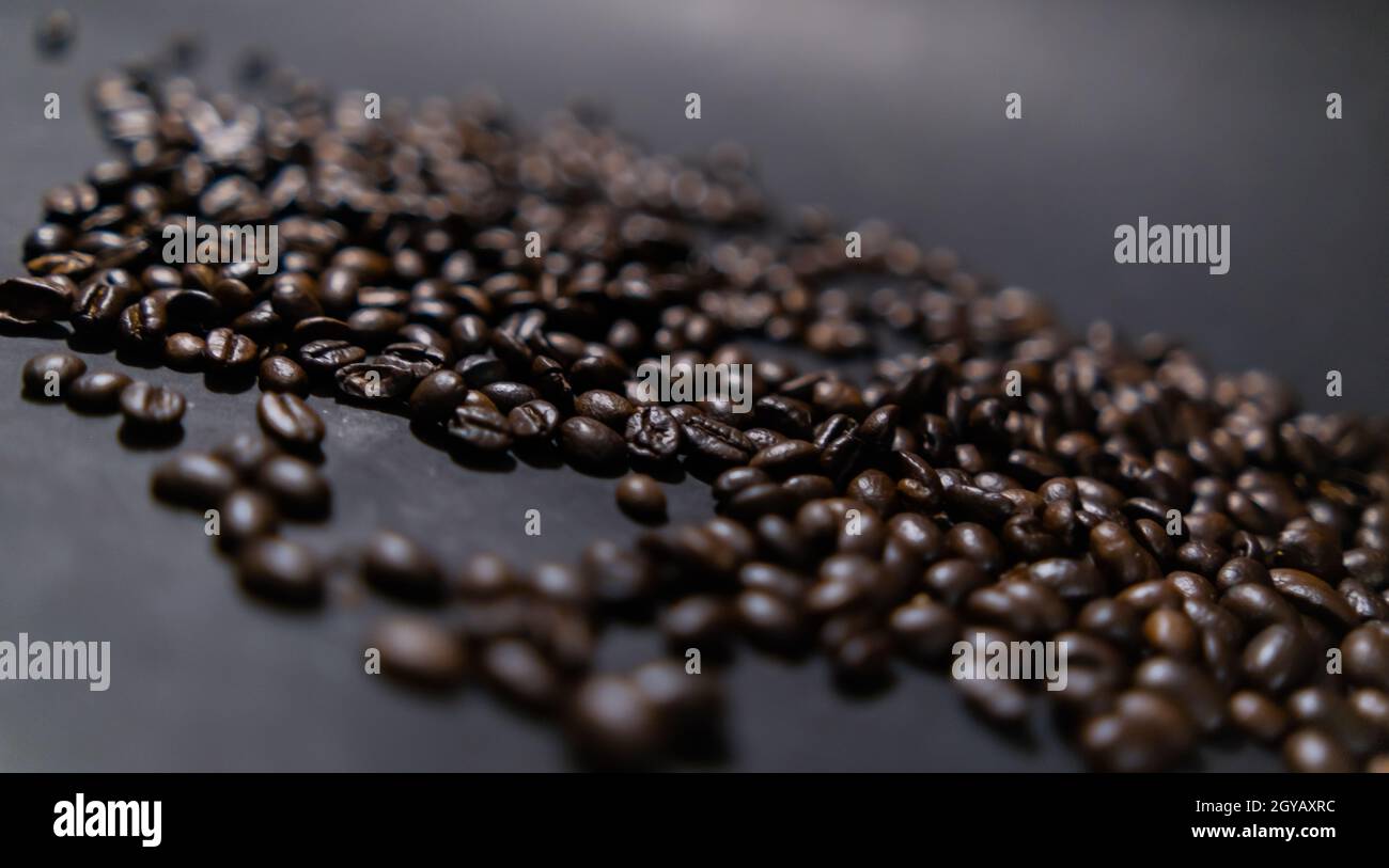 Pile of roasted coffee beans with dark gray background Stock Photo - Alamy