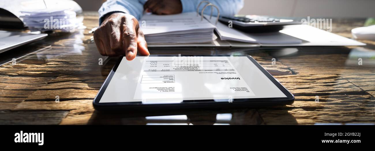 E Invoice Receipt On Tablet Computer. Accountant Manager Checking Bills Stock Photo