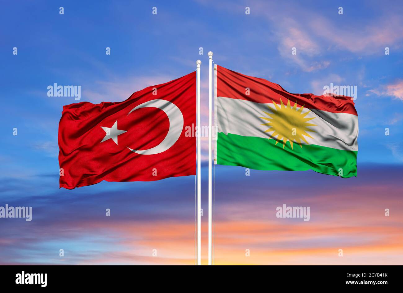 Kurdistan and Turkey  flag waving in the wind against white cloudy blue sky together. Diplomacy concept, international relations Stock Photo
