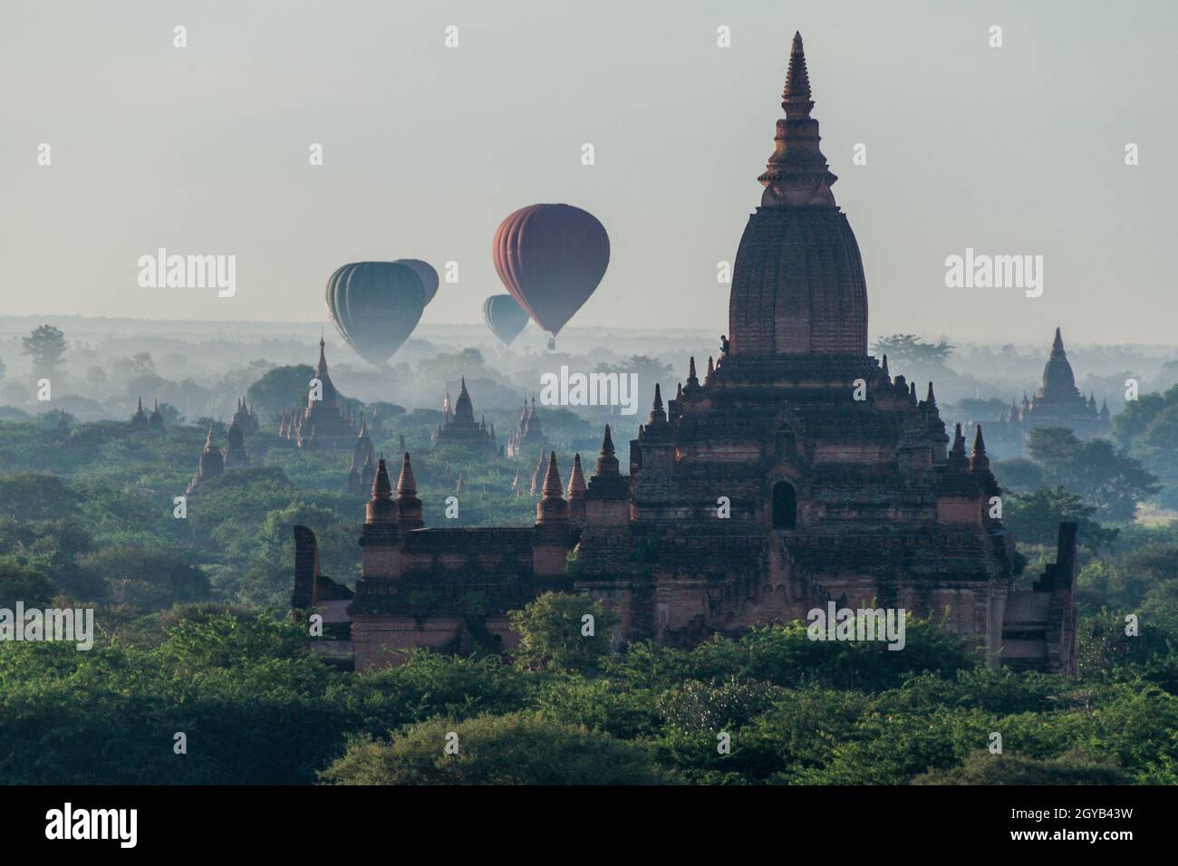 Balloon over Bagan - hot air balloons floating among the skyline of temples, Myanmar Stock Photo