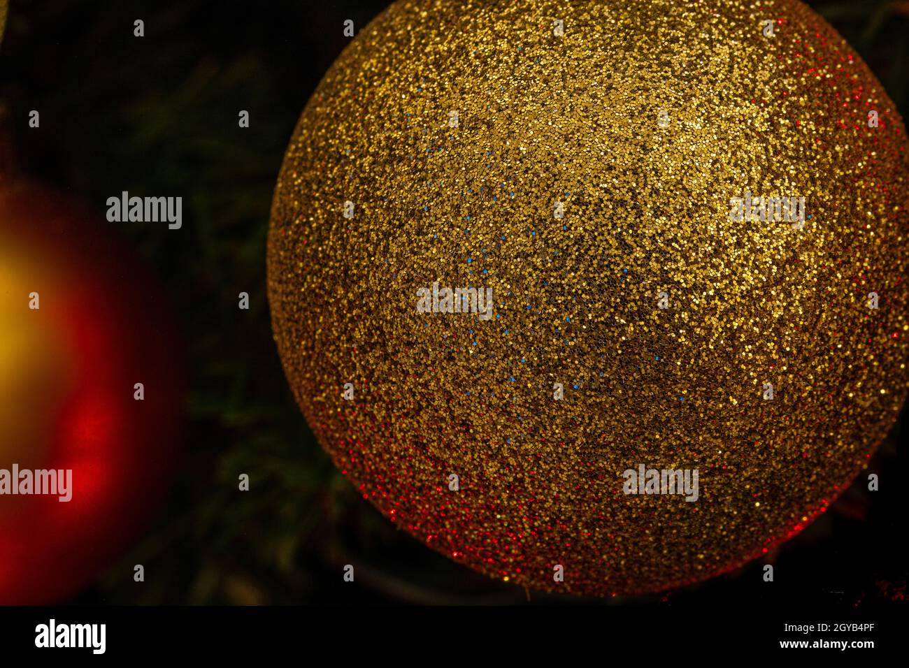 Various Christmas tree decorations and red blurred light on background Stock Photo