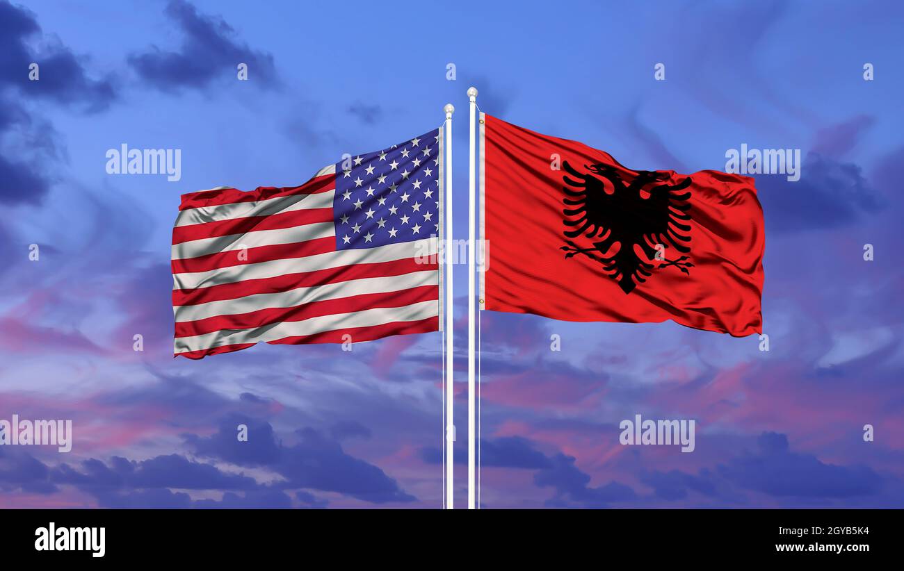Albania and United States flag waving in the wind against white cloudy blue sky together. Diplomacy concept, international relations. Stock Photo