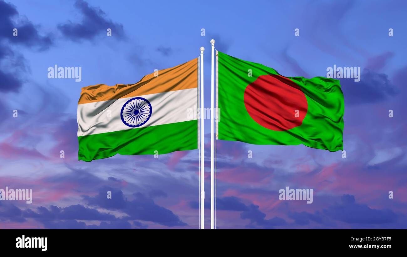 India and Bangladesh two flags on flagpoles and blue cloudy sky Stock Photo