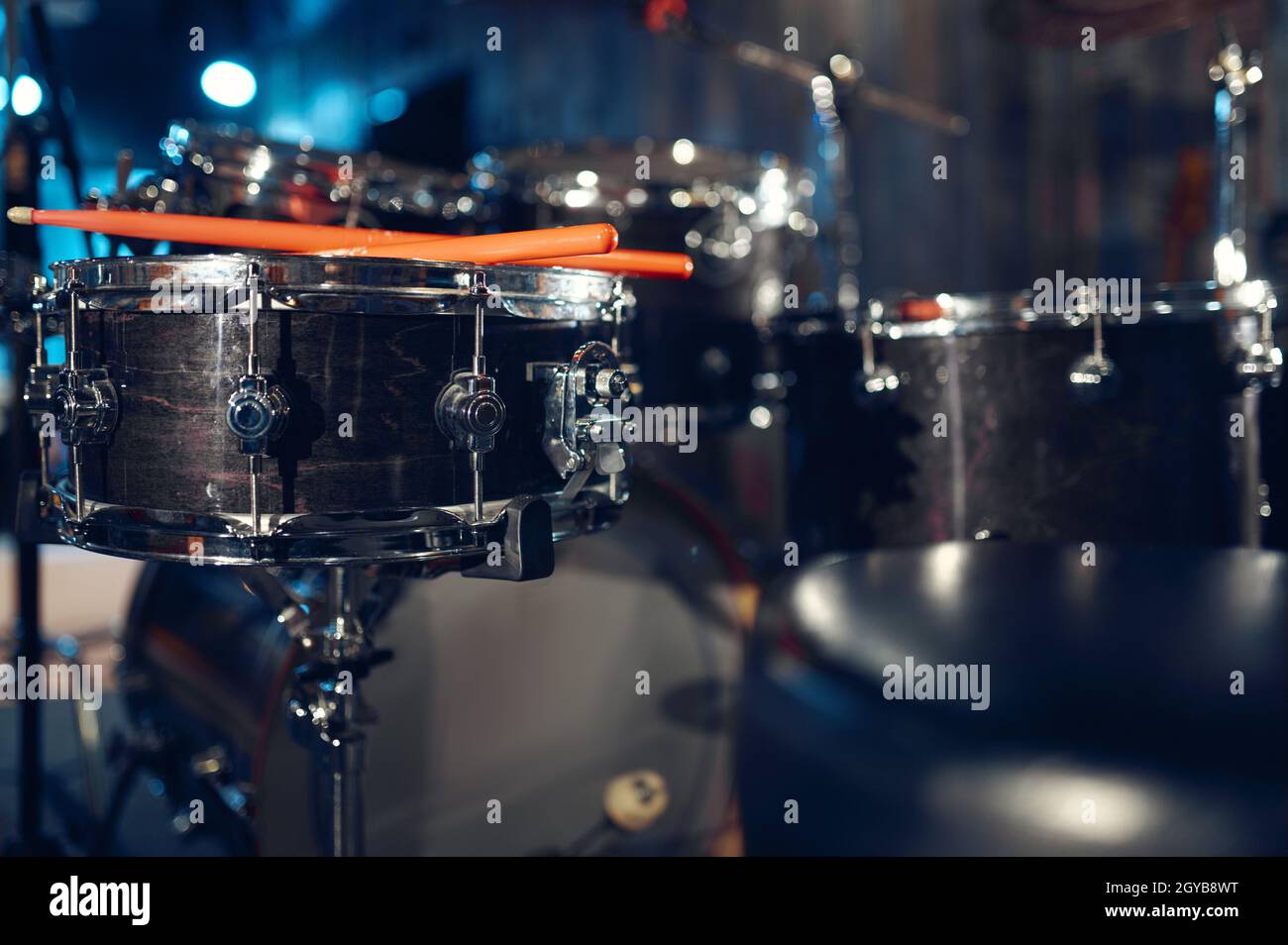 Professional drum kit and sticks closeup, nobody. Rock band concert