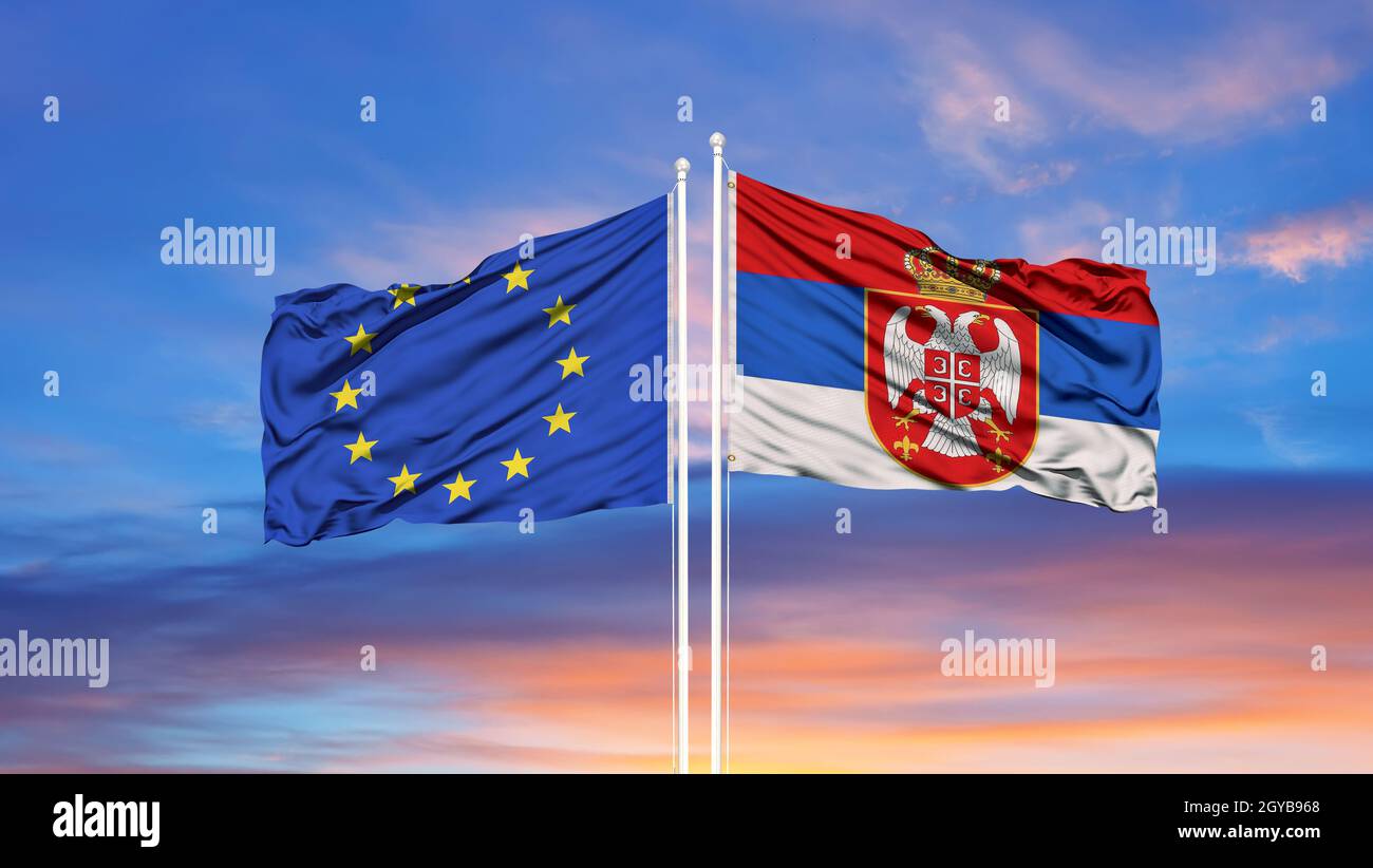 Serbia and European Union two flags on flagpoles and blue sky Stock Photo