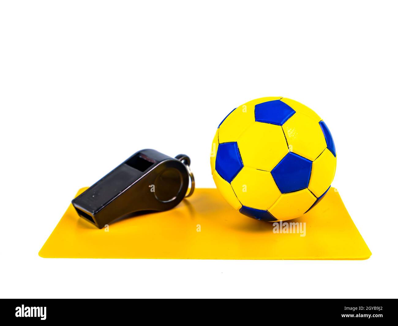 Soccer ball and yellow card with the whistle of a soccer referee on a white background. Football. Championship. World. Europe. Referee. Place for text Stock Photo