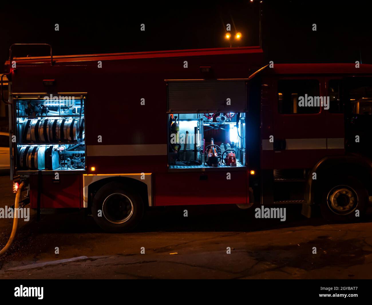 Fire engine during a fire extinguishing at night. Emergency. Help. Background image. Stock Photo