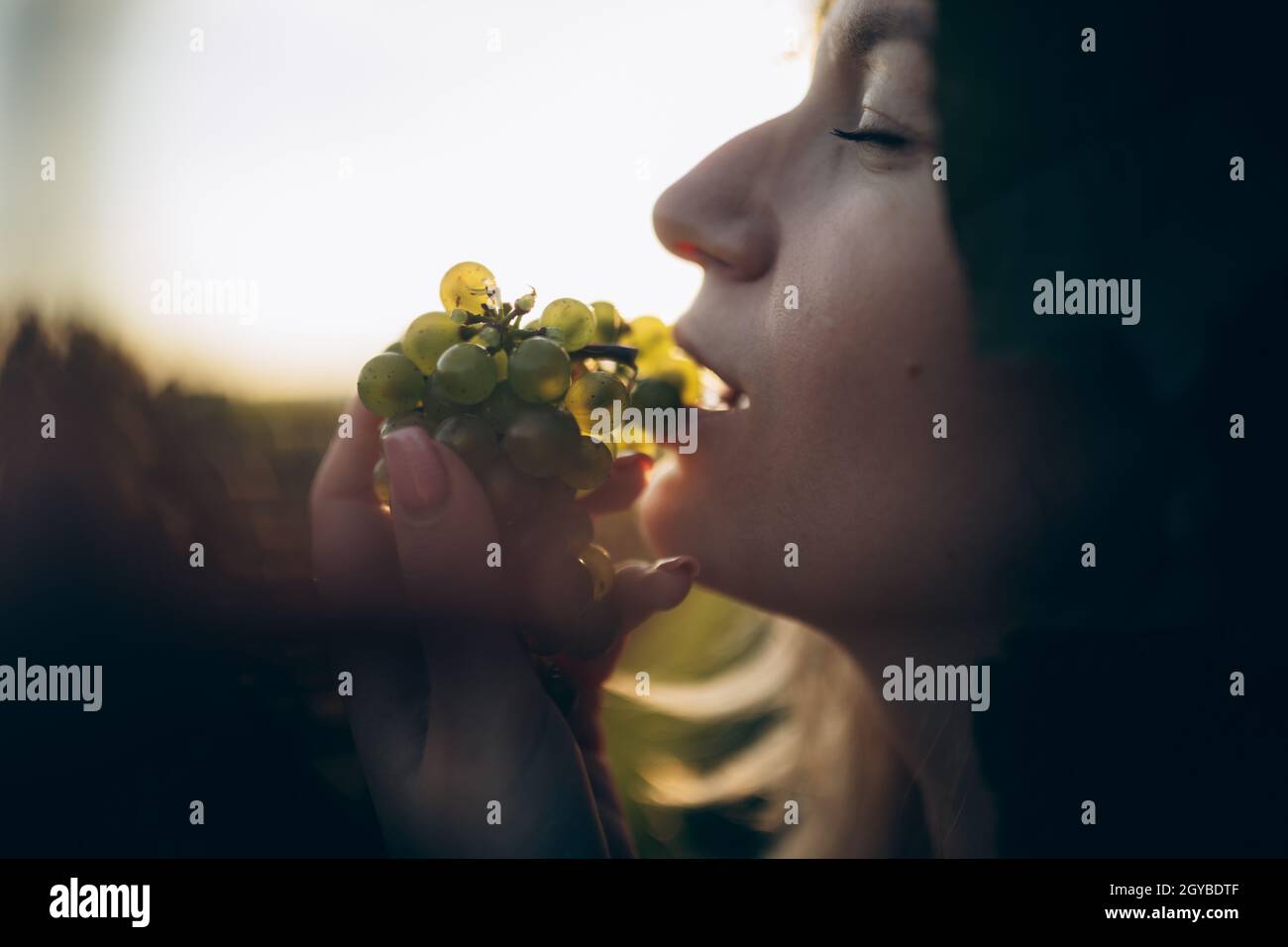 Woman bunch black grapes hi-res stock photography and images - Alamy