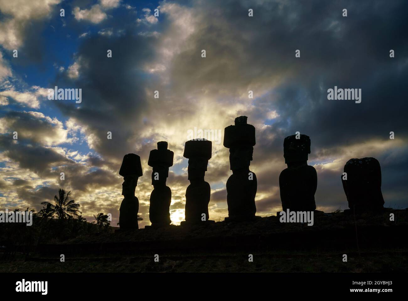 Silhouette shot of Moais at Anakena beach in Easter Island Chile sunset Stock Photo
