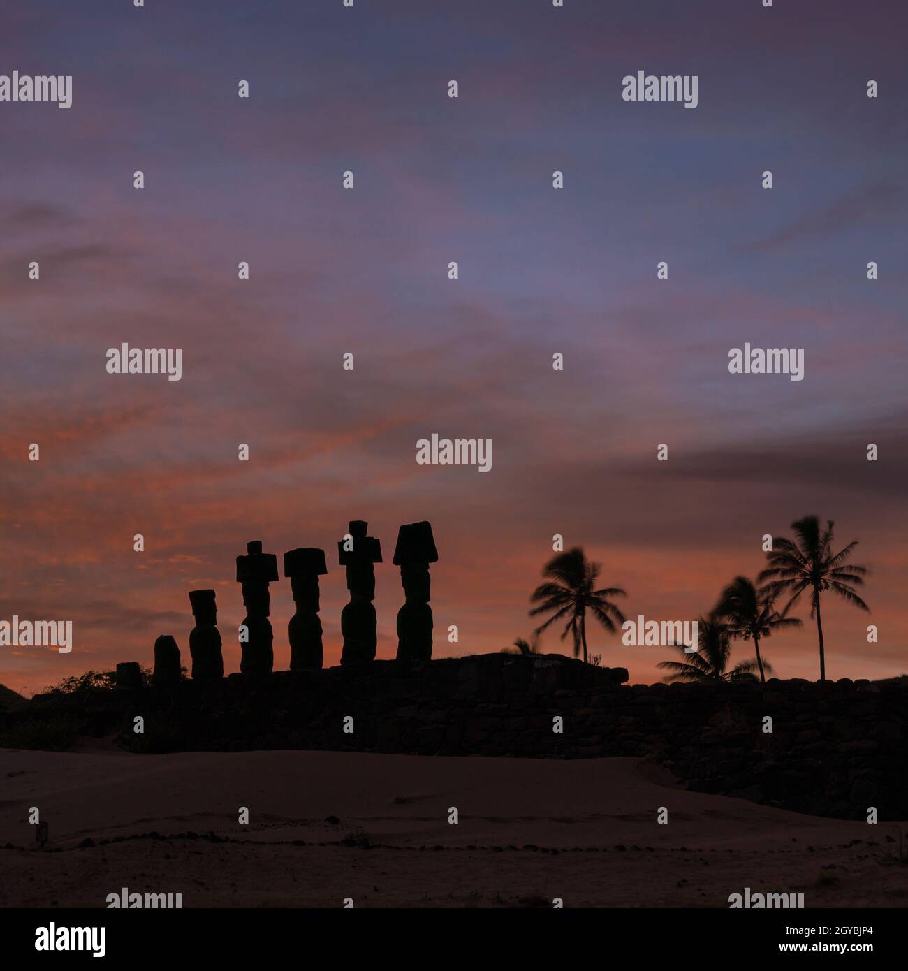 Silhouette shot of Moais at Anakena beach in Easter Island Chile sunrise Stock Photo