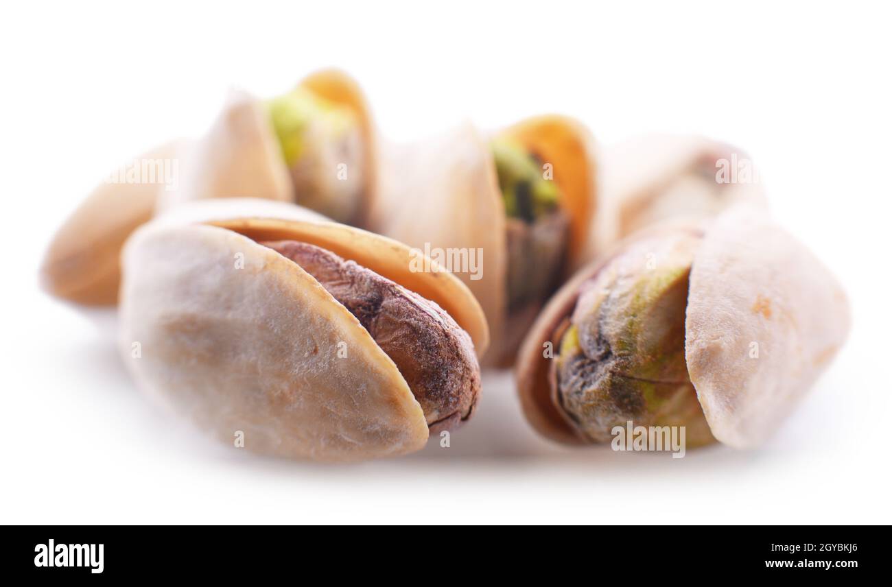 Composition with pistachios in the shells isolated on white Stock Photo