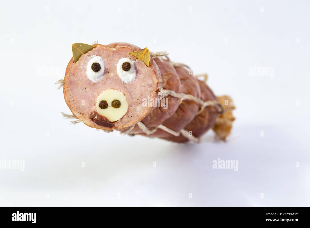 salami with a pig's face made from cheddar cheese, pepper and bay leaves.  Selective focus Stock Photo - Alamy