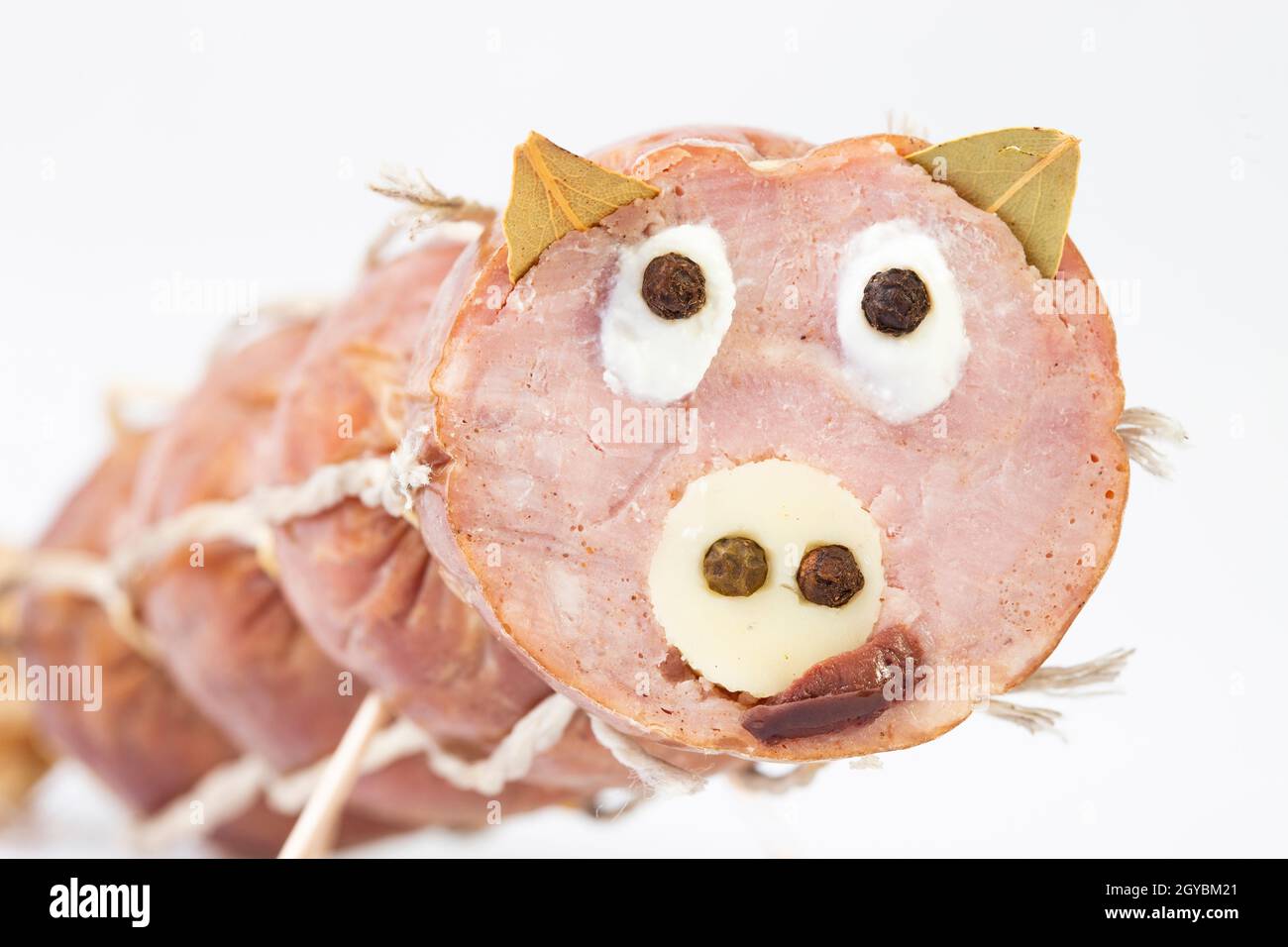 Selective focus photo of a funny pig's face made from a pork salami, cheese, bay leaves and black pepper Stock Photo - Alamy Selective focus photo of a funny pig's face made from a pork salami, cheese, bay leaves and black pepper Stock Photo - Alamy