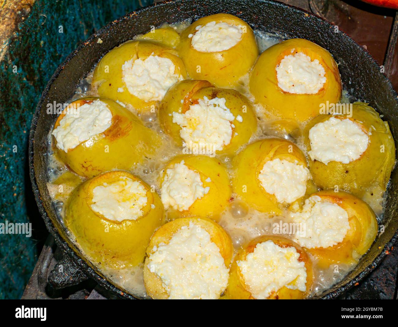 Baked apples stuffed with cottage cheese in a pan. Food photo. Sweet food menu. Dessert. Cooking food. Home kitchen. Showcase advertising photo. Place Stock Photo