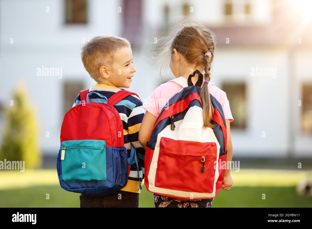 Children with backpacks going to the school. Concept of knowledge