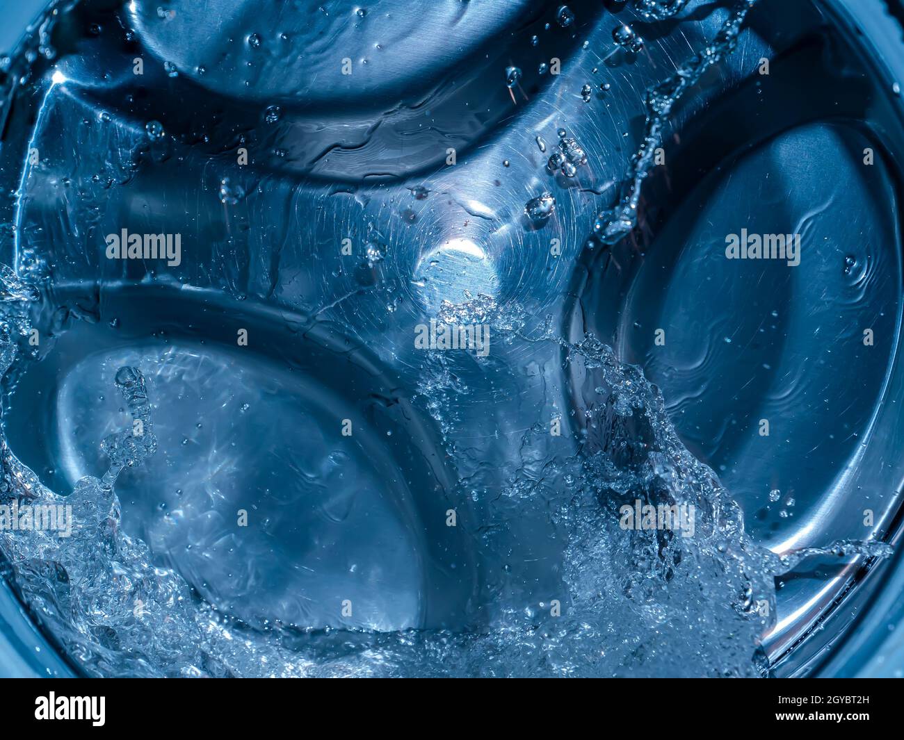 Rotating drum in the washing machine tub with water. Washer. Automatic