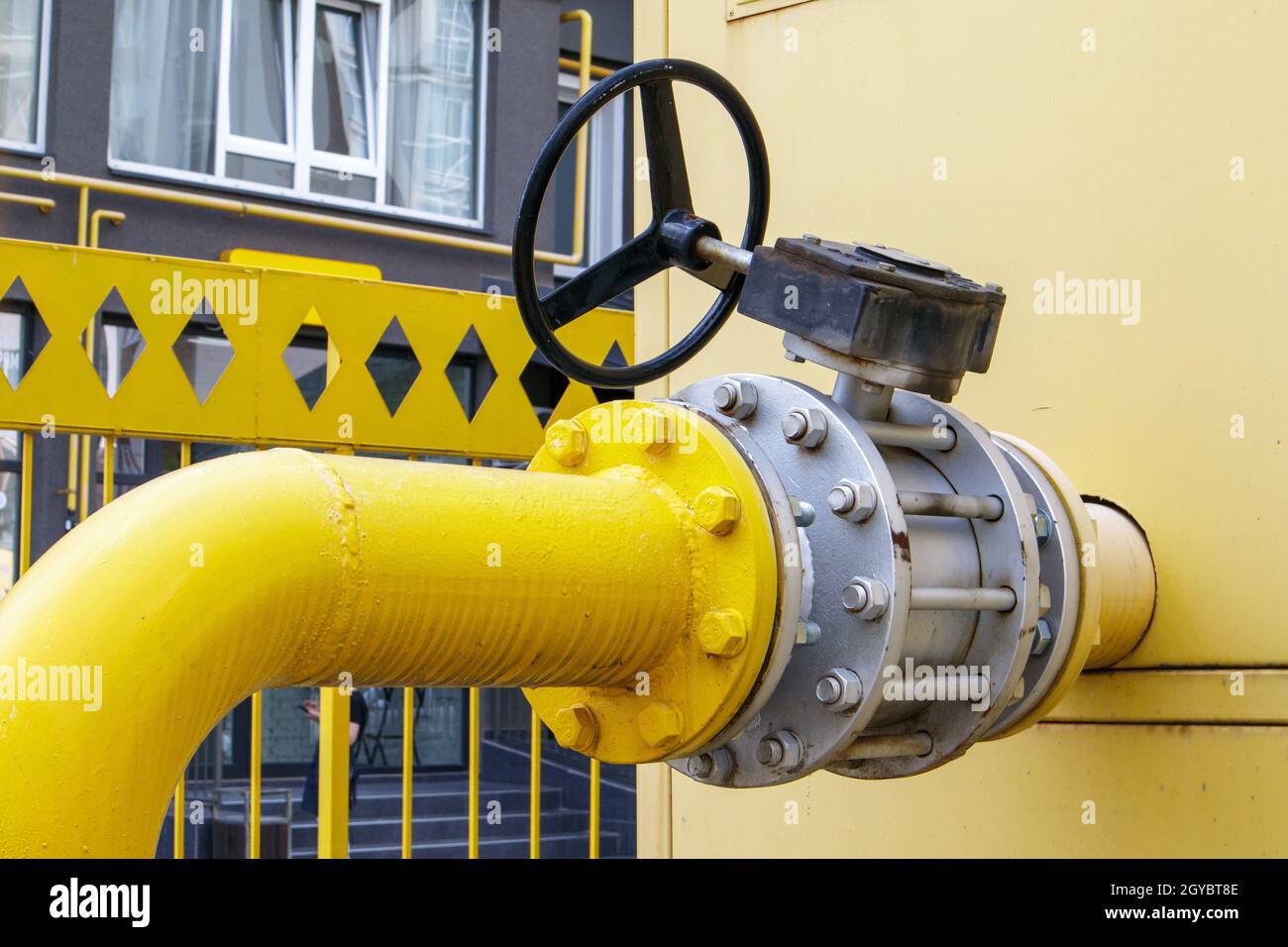 Yellow gas pipe with a tap. Oil pipeline fittings in the oil and gas ...