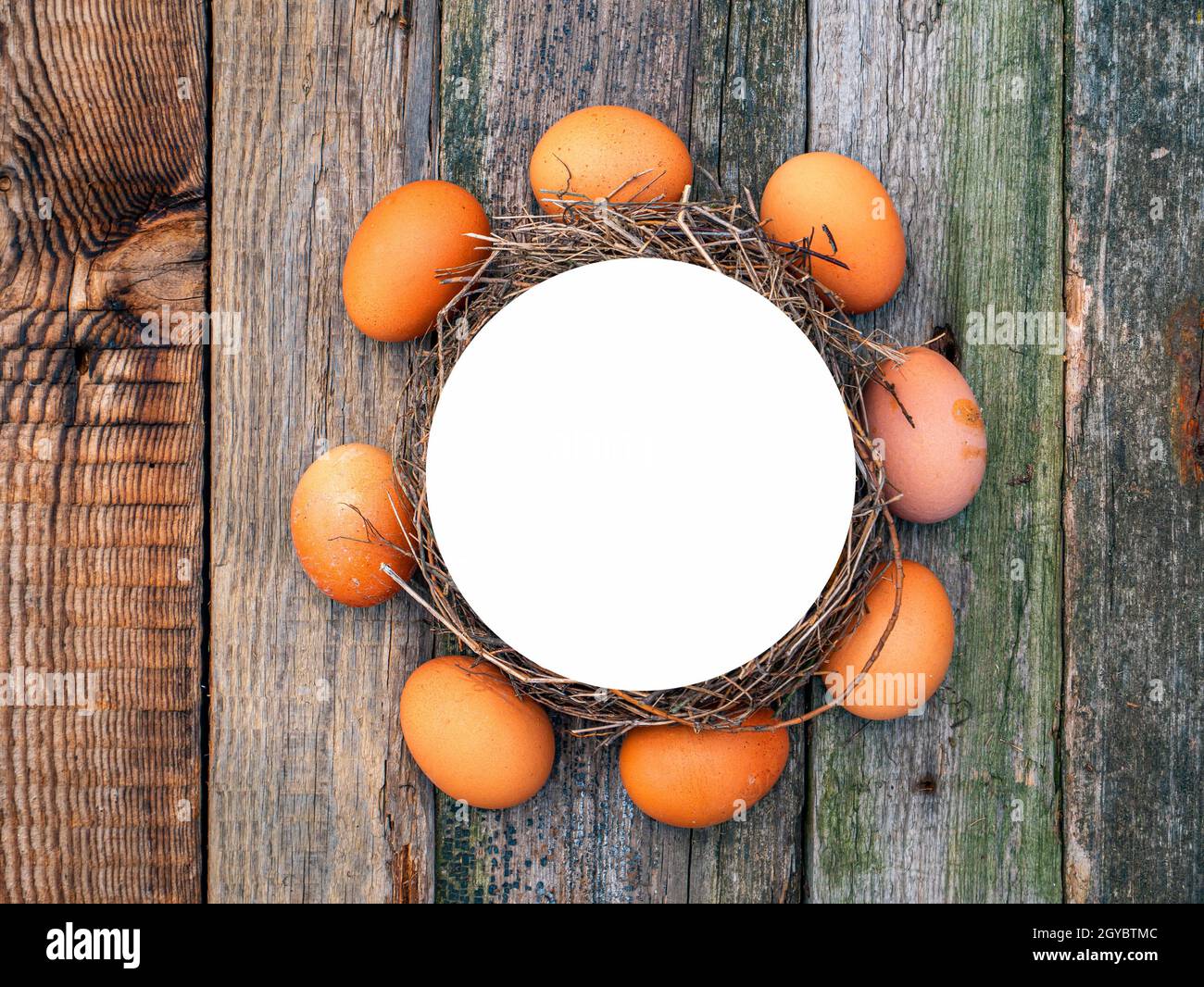 A circle of chicken eggs on a wooden table. Chicken eggs. Wooden table ...