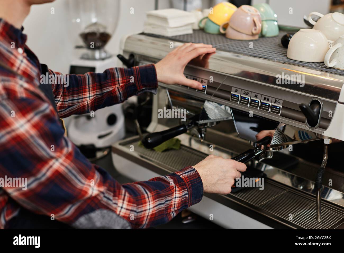 Barista using a coffee machine to make coffee in cafe Stock Photo Alamy