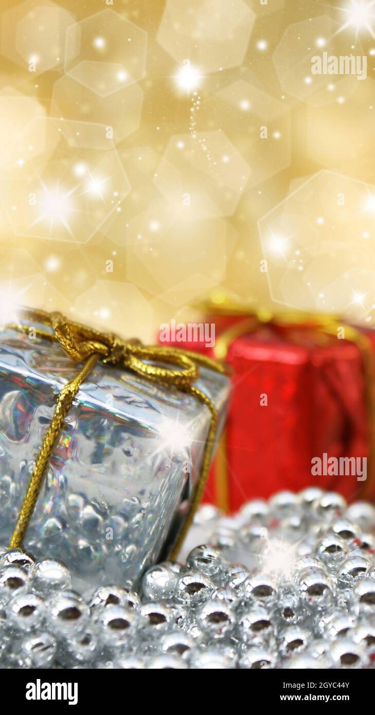 Christmas gifts on glittery gold background Stock Photo - Alamy