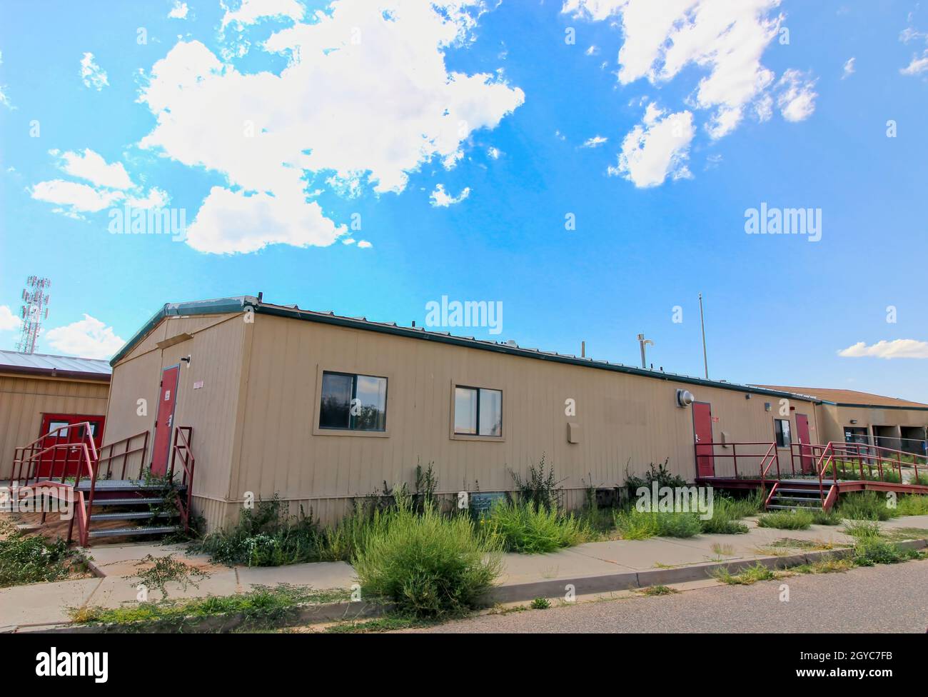 Abandoned Prefabricated Building With Overgrown Weeds Stock Photo