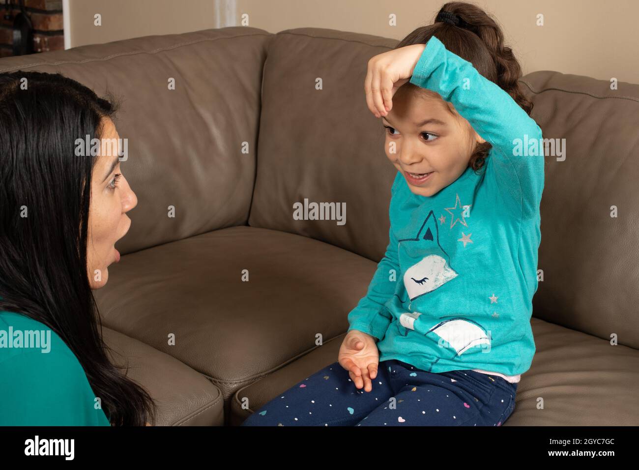 Five year old girl talking to her mother at home Stock Photo Alamy