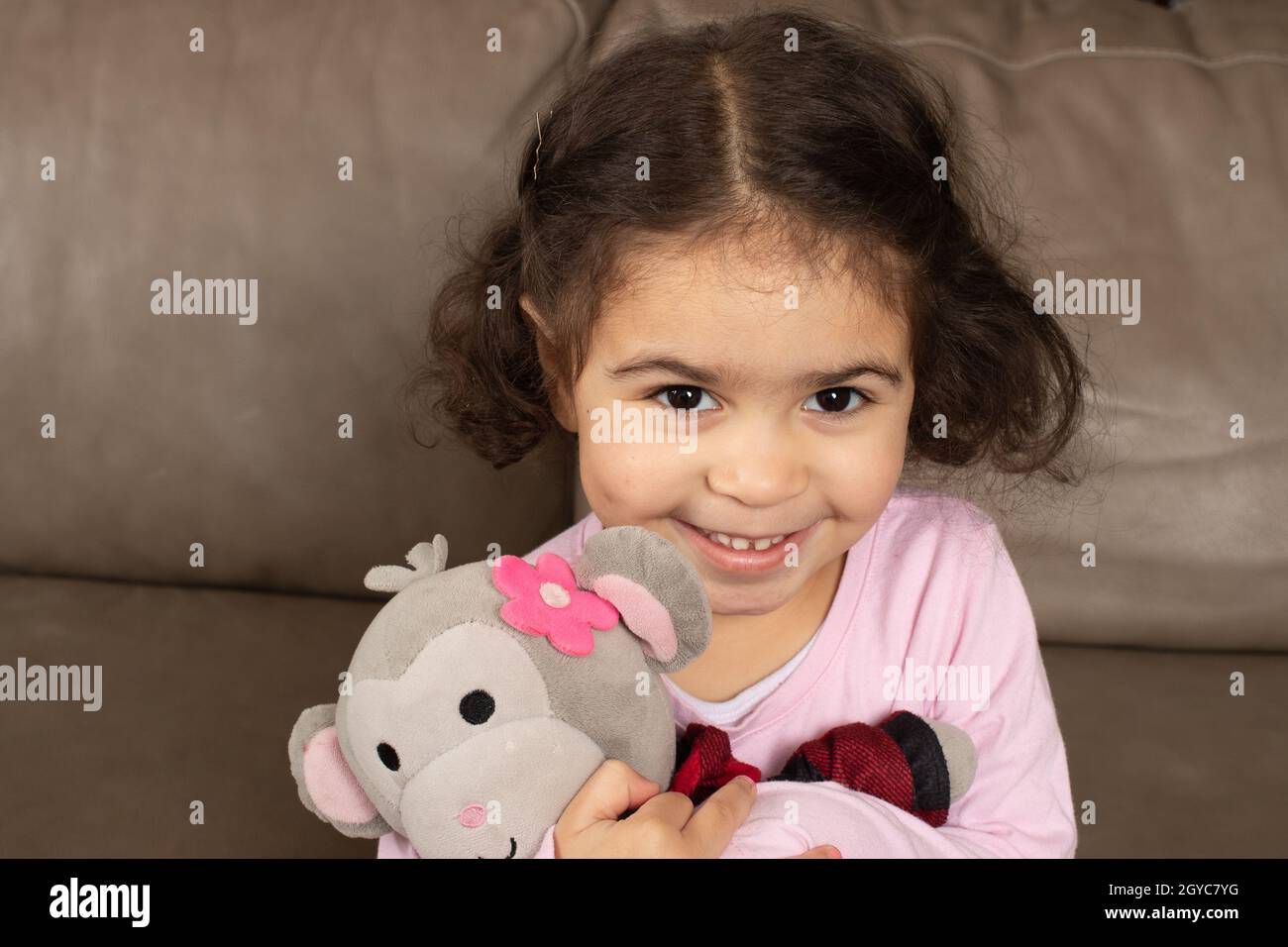 3 year old girl with favorite stuffed animal toy Stock Photo