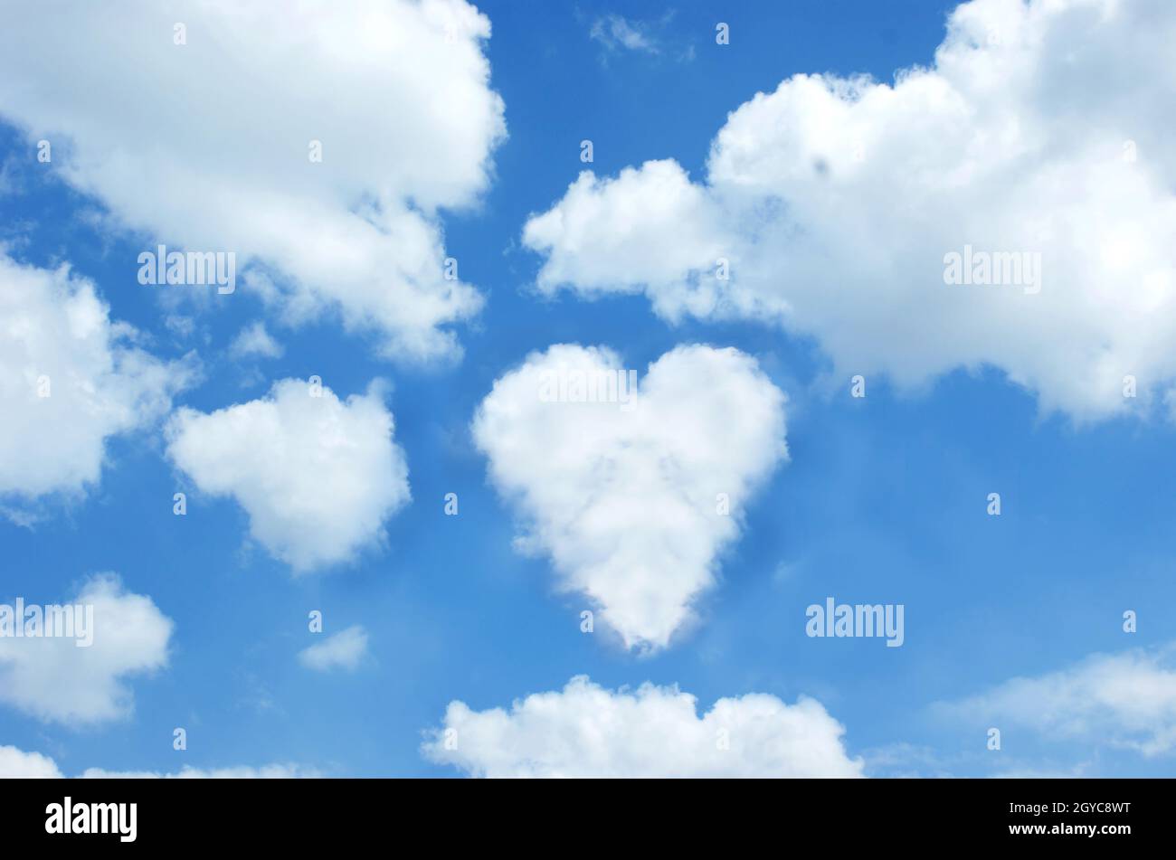 Sunny blue sky with a cloud in the shape of a heart Stock Photo - Alamy