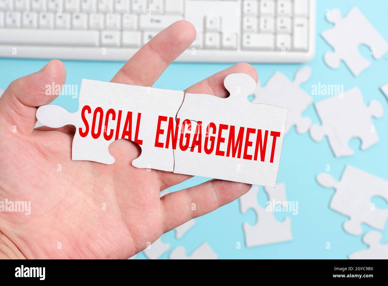 Hand writing sign Social Engagement, Internet Concept one s is degree of participation in a community or society Building An Unfinished White Jigsaw P Stock Photo