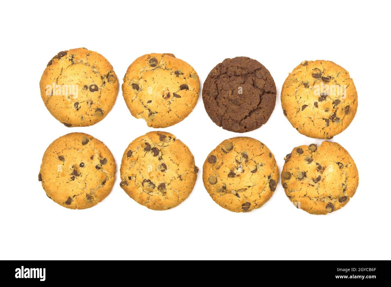 One dark chocolate chips cookie among the light ones isolated on white background with clipping path Stock Photo
