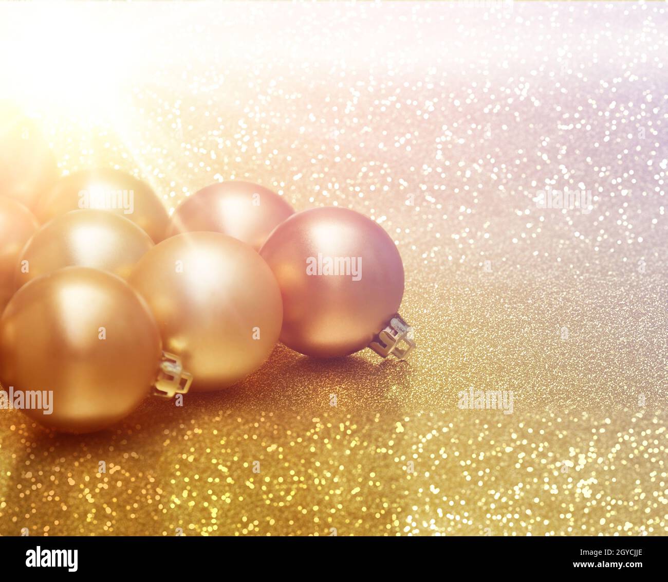 Christmas baubles on glittery gold background Stock Photo - Alamy