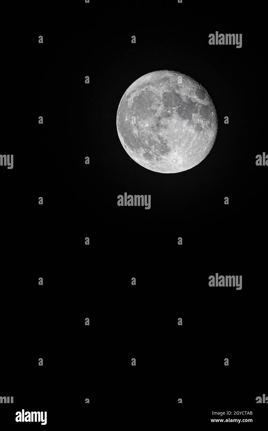 A bright full moon isolated in the black night sky Stock Photo - Alamy