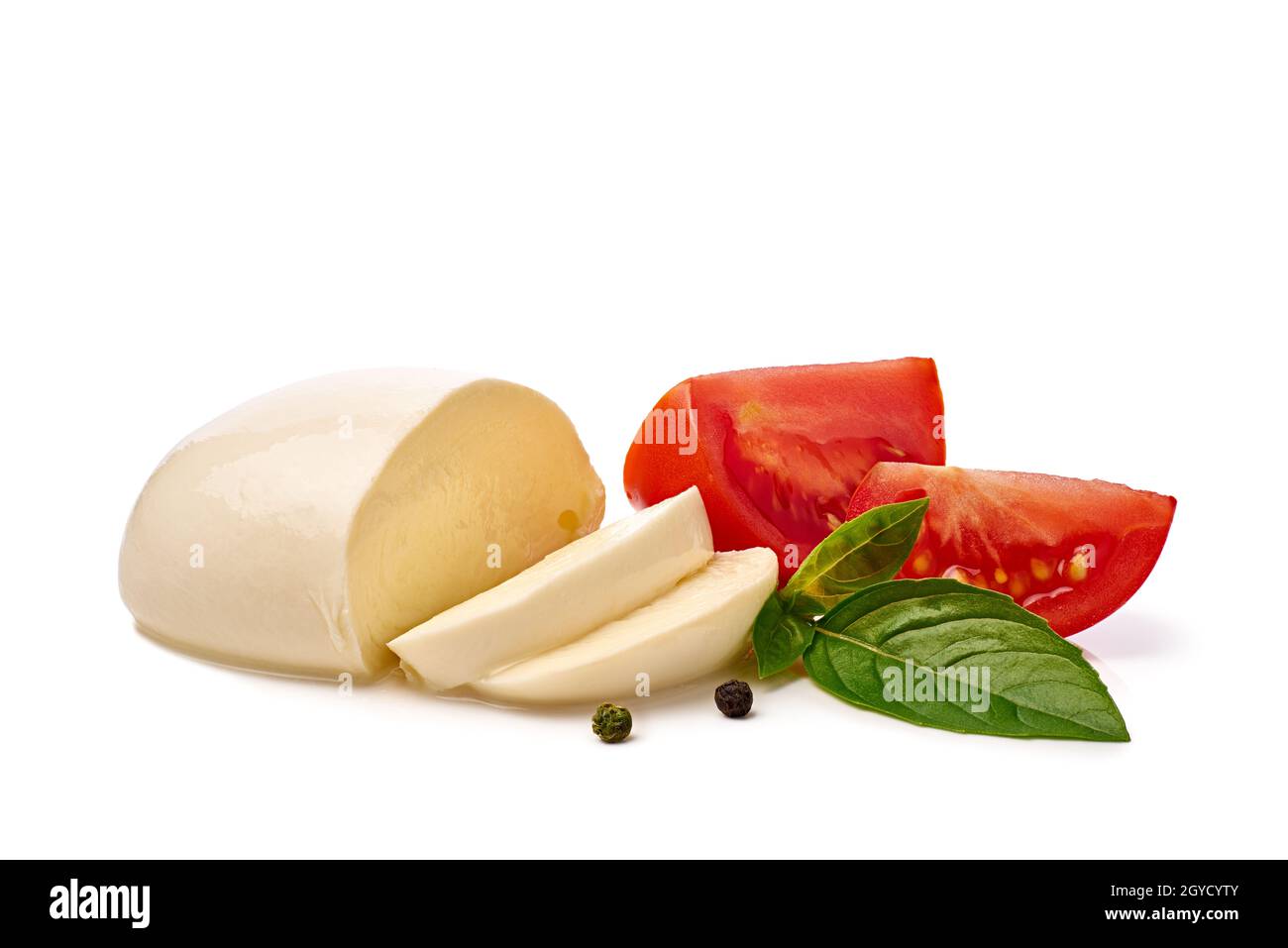 Fresh sliced mozzarella cheese with tomato and basil on white Stock Photo