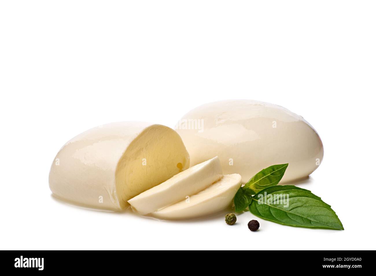 Pieces of fresh mozzarella cheese with basil leaves on white Stock Photo