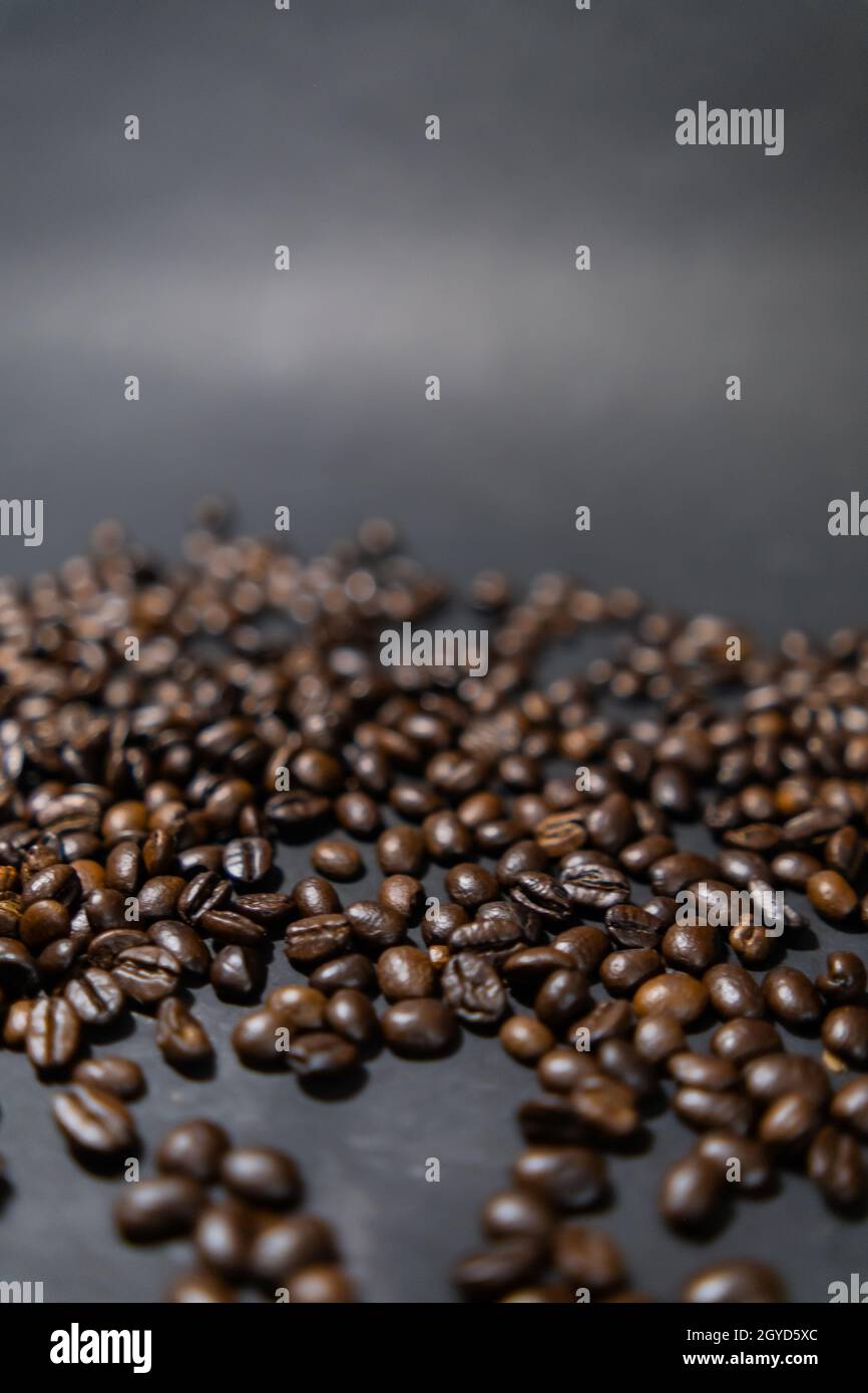 Pile of roasted coffee beans with dark gray background Stock Photo - Alamy