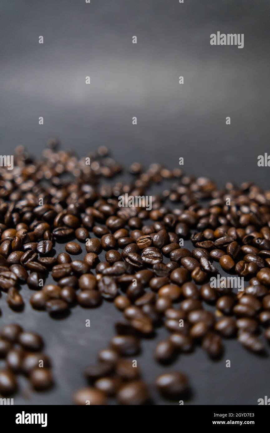 Pile of roasted coffee beans with dark gray background Stock Photo - Alamy