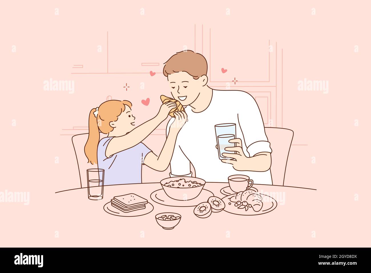 Happy Fathers day, spending time with children concept. Smiling happy young man father and his small daughter sitting and having breakfast together at Stock Photo